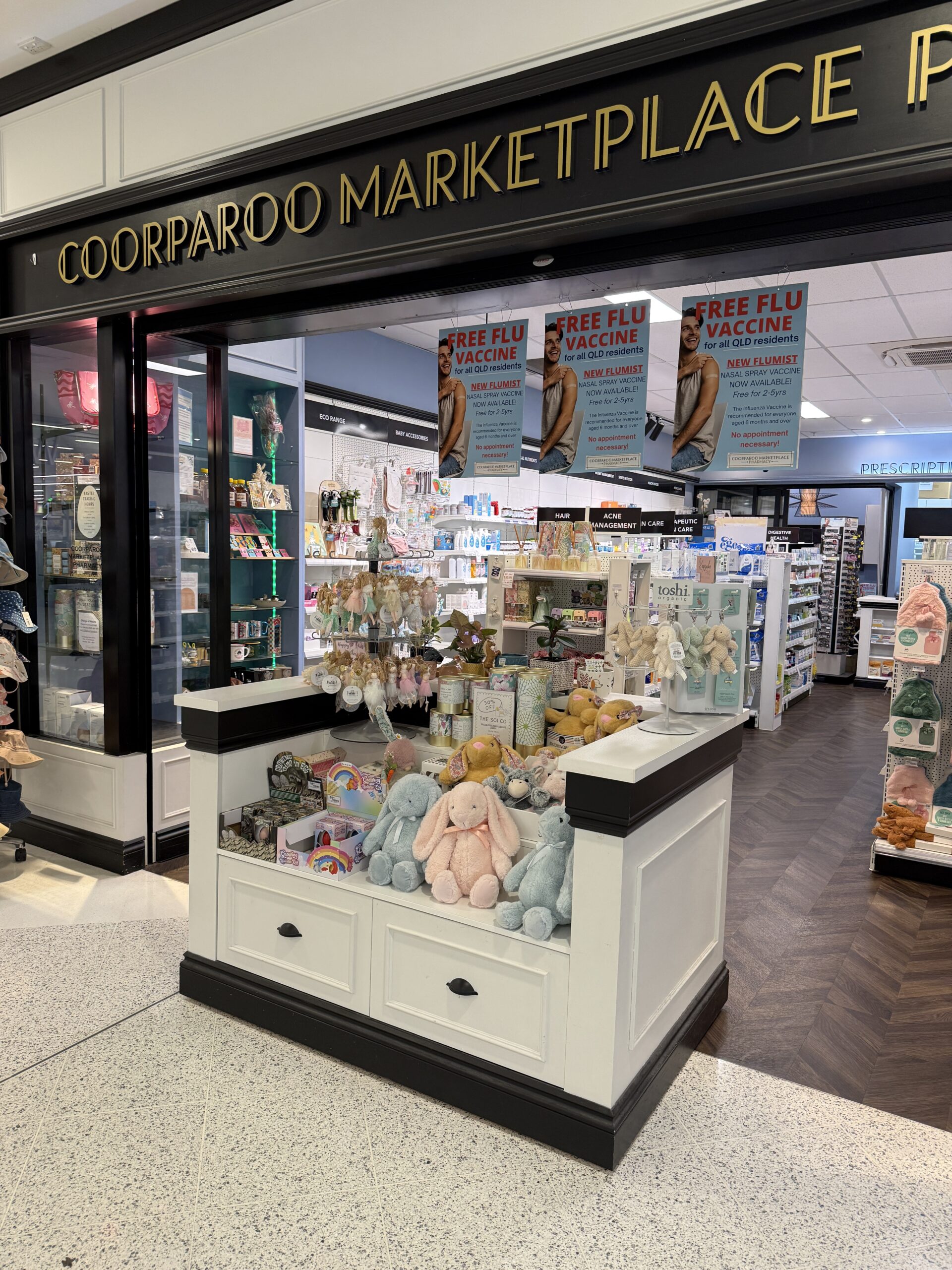 Coorparoo Marketplace Pharmacy store entrance — gold art deco fascia, boutique independent pharmacy at Shop 9B Coorparoo Marketplace