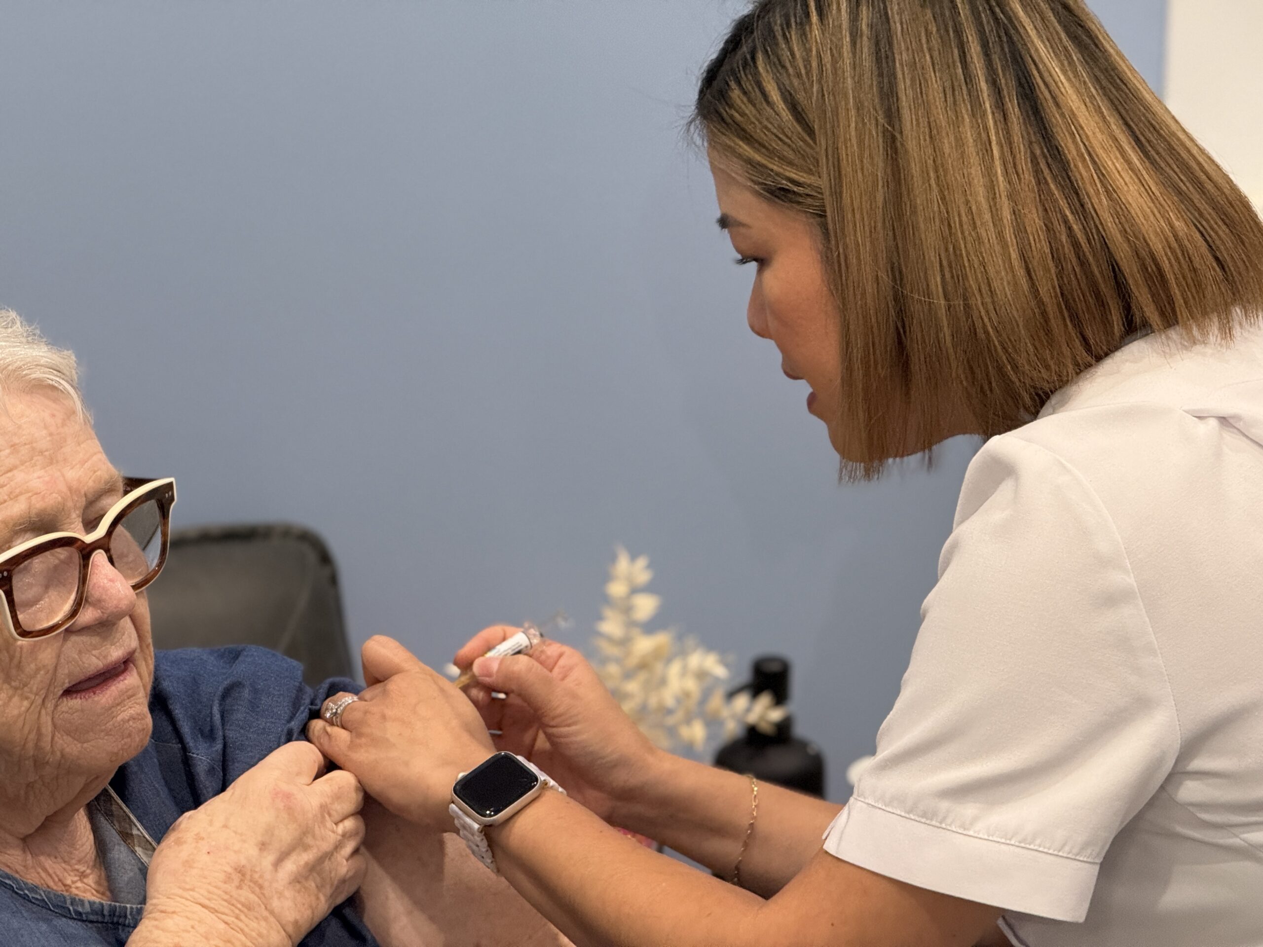 Pharmacist administering flu vaccination Coorparoo 2026 at Coorparoo Marketplace Pharmacy